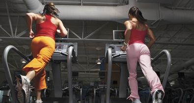two girls running on a treadmill